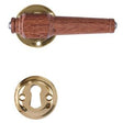 Svanemølle hardwood door handle with rose and keyhole escutcheon in unlacquered polished brass