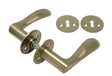 Bellevue door handle in unlacquered brushed brass, with rose and keyhole escutcheon, 30 mm fixing centres